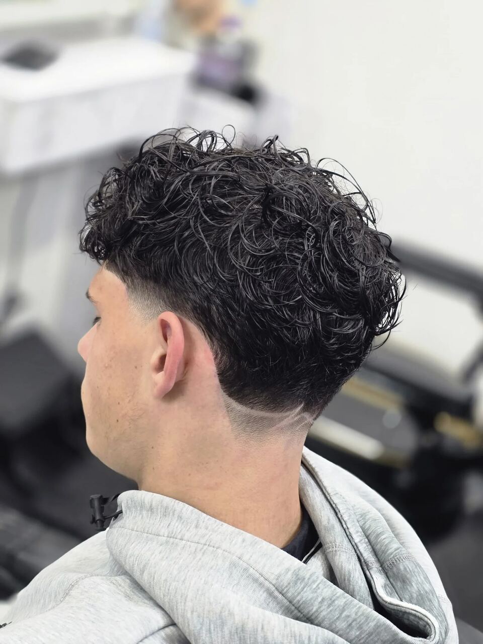 A curly top with a low taper