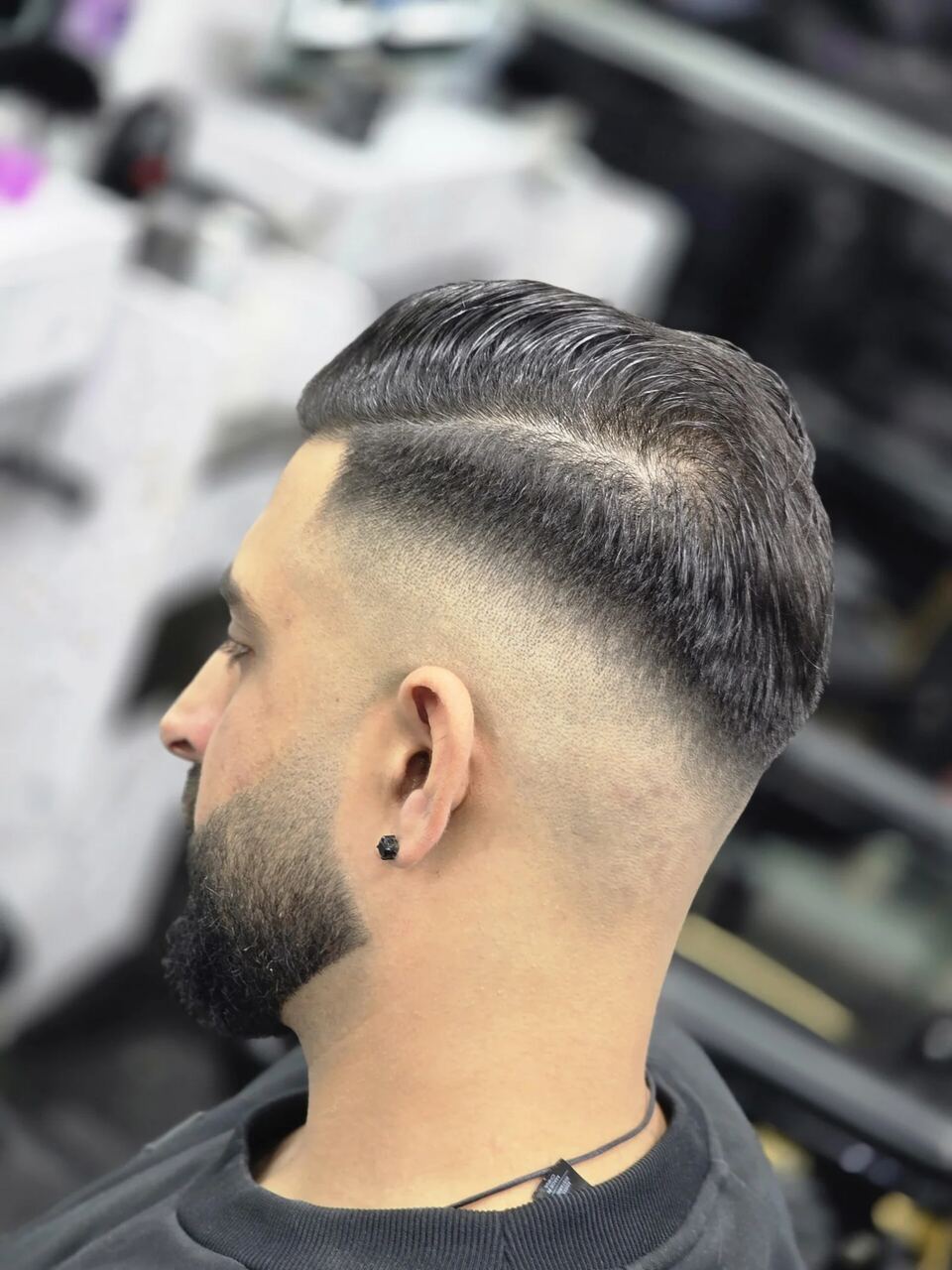 A skin fade with a hard part and a shaped beard, cut at AK Barbers